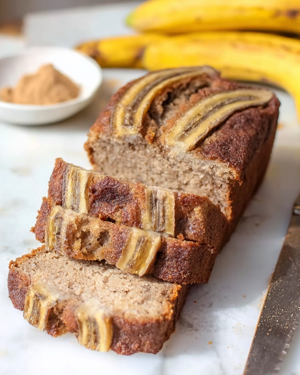 The image shows a sliced banana bread loaf on a white marbled surface. The bread has a moist, dense texture with a light brown color inside and a slightly darker crust. There are three visible slices in front of the loaf, each showing a thick slice of banana on top with a brownish-yellow peel and dark brown stripe. A bunch of ripe bananas with yellow skins and brown spots is out of focus in the background, along with a small white bowl containing a powdery brown ingredient. A knife with a dark handle is partially visible to the right. Photo taken with an iphone --ar 4:5 --v 7