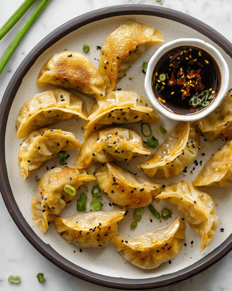 A white round plate with a dark rim holds a single layer of about fourteen golden-brown pan-fried dumplings arranged in a loose circle. The dumplings have a lightly crisp, pleated outer skin with some translucent spots showing the filling inside. Small black and white sesame seeds are sprinkled across the dumplings. In the upper right of the plate, a small white bowl filled with a dark soy dipping sauce topped with red chili flakes and small green onion pieces sits nestled among the dumplings. A few chopped green onions are scattered around the plate on a white marbled surface. photo taken with an iphone --ar 4:5 --v 7