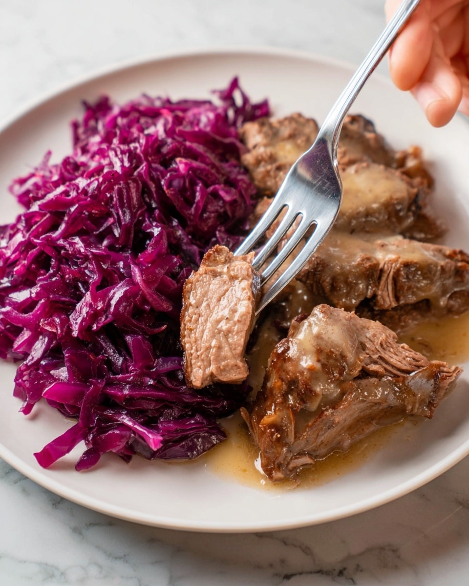 A close-up photo of a white plate with two main parts: on the left, a pile of shredded purple cabbage with a glossy texture, and on the right, several pieces of brown cooked meat with visible fibers and a soft texture, covered in a light brown creamy sauce that shines under the light. A silver fork held by a woman's hand is lifting one piece of the meat, showing its tender inside with a pinkish center. The plate is set on a white marbled surface. photo taken with an iphone --ar 4:5 --v 7