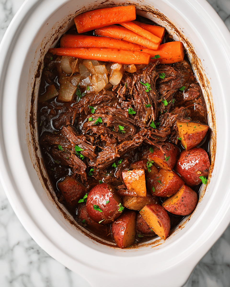 The image shows a white slow cooker filled with a rich beef stew. The stew has three main layers: at the top, orange carrot sticks with a soft texture and bits of chopped onions scattered around, to the left and center, tender shredded dark brown beef soaking in a thick sauce with onions visible, and near the bottom right, roasted potato chunks in reddish-brown color, some with a slight shine, all garnished with small green parsley pieces. The inside of the slow cooker has some sauce stains along the sides. The background is a white marbled texture. photo taken with an iphone --ar 4:5 --v 7